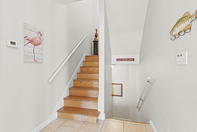 stairs featuring tile patterned flooring