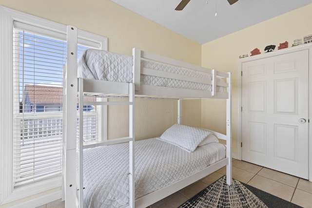 bedroom featuring ceiling fan and tile patterned flooring