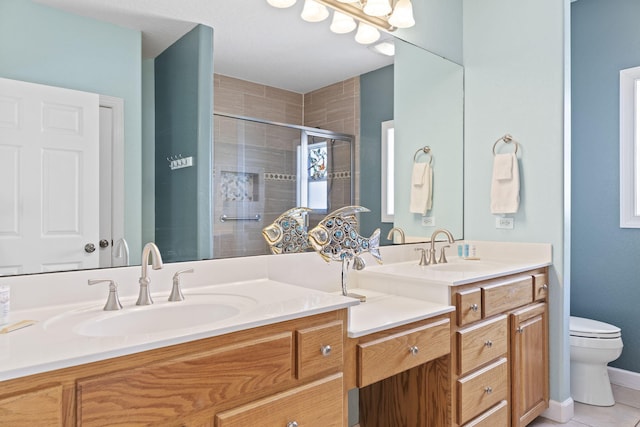 bathroom with tile patterned flooring, vanity, toilet, and an enclosed shower