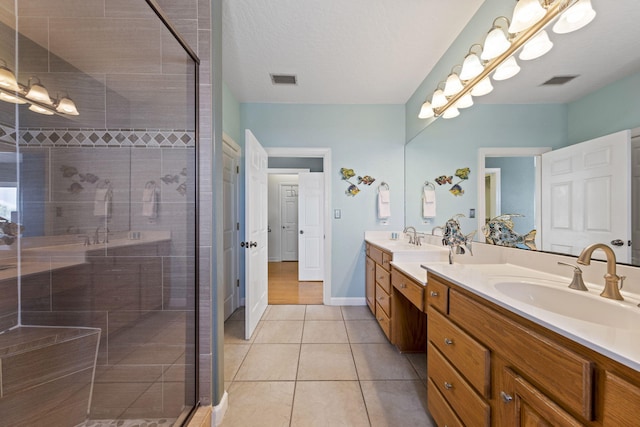 bathroom featuring tile patterned flooring, vanity, and an enclosed shower