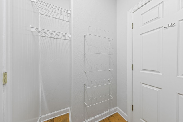 walk in closet featuring hardwood / wood-style flooring