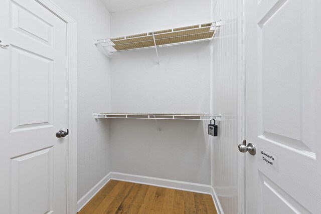 spacious closet featuring hardwood / wood-style floors