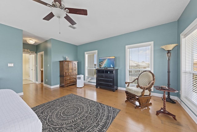 sitting room with ceiling fan, hardwood / wood-style floors, and a healthy amount of sunlight