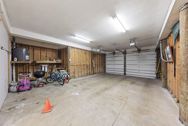 garage featuring a garage door opener and water heater