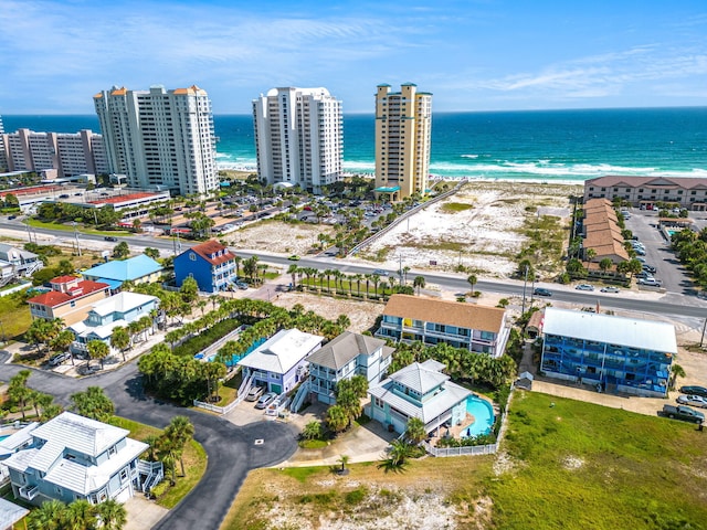 aerial view with a water view and a beach view