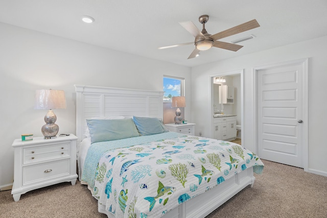 carpeted bedroom with connected bathroom and ceiling fan