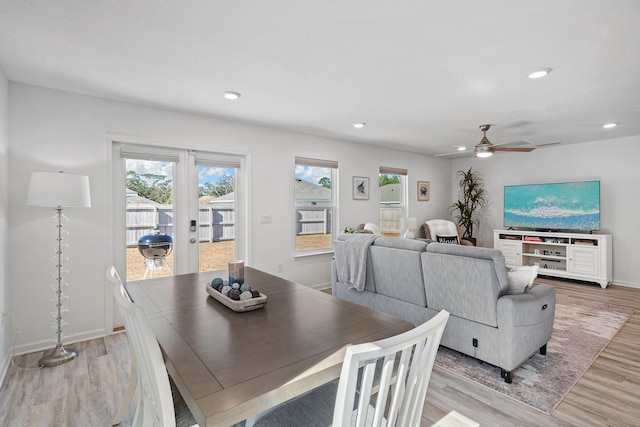 dining room featuring ceiling fan, light wood-type flooring, and french doors