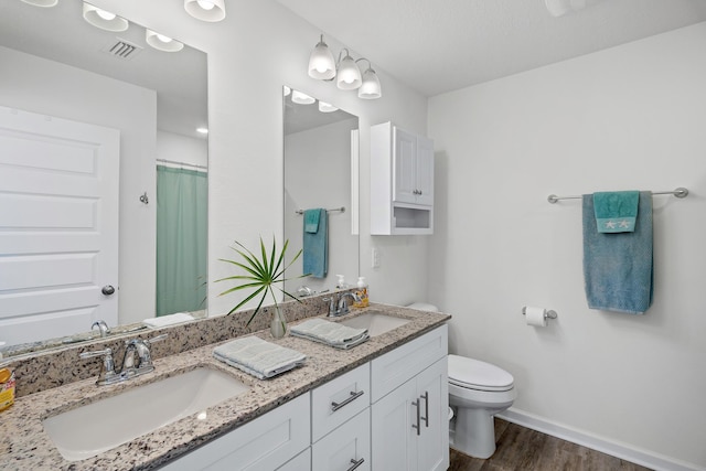 bathroom featuring hardwood / wood-style flooring, vanity, toilet, and a shower with shower curtain