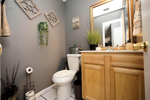 bathroom with tile patterned flooring, vanity, and toilet