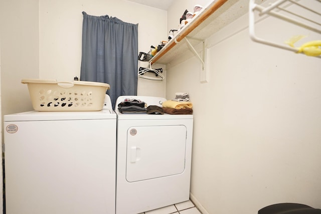 laundry area featuring washer and clothes dryer and light tile patterned floors