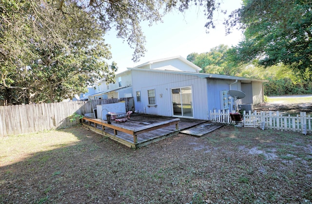 back of house with a deck