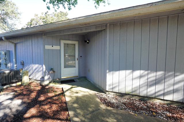 view of exterior entry featuring central AC unit