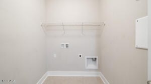 washroom featuring baseboards, hookup for an electric dryer, hookup for a washing machine, and laundry area