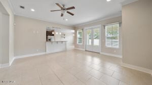 unfurnished living room featuring recessed lighting, baseboards, crown molding, and ceiling fan