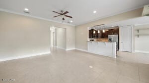 unfurnished living room featuring crown molding, light tile patterned floors, recessed lighting, and baseboards