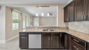 kitchen with a sink, light stone counters, stainless steel dishwasher, a peninsula, and dark brown cabinets