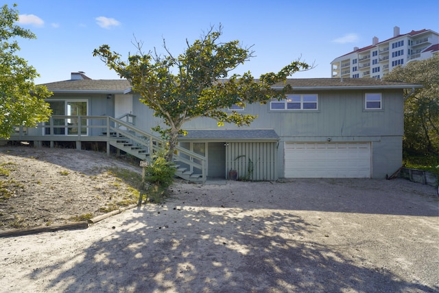 view of front facade with a garage and a deck