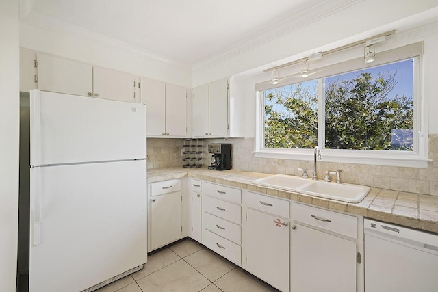 kitchen featuring white cabinetry, sink, white appliances, light tile patterned flooring, and ornamental molding