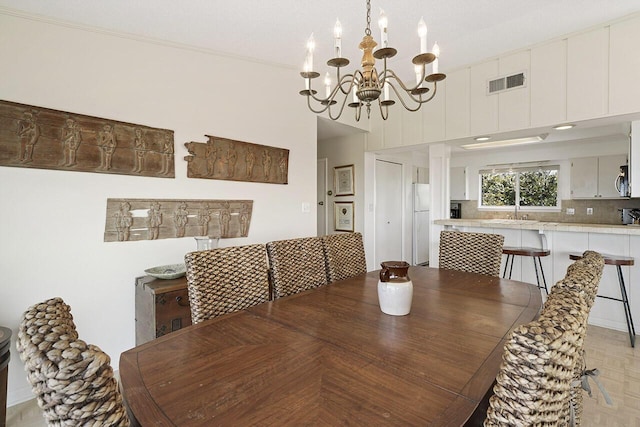 dining area with sink and a chandelier