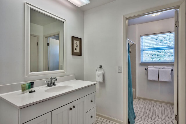 bathroom featuring tile patterned flooring, vanity, and shower / bath combo with shower curtain