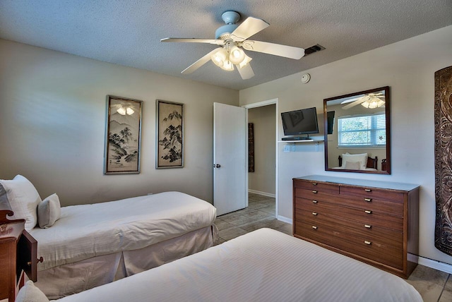 bedroom featuring a textured ceiling and ceiling fan