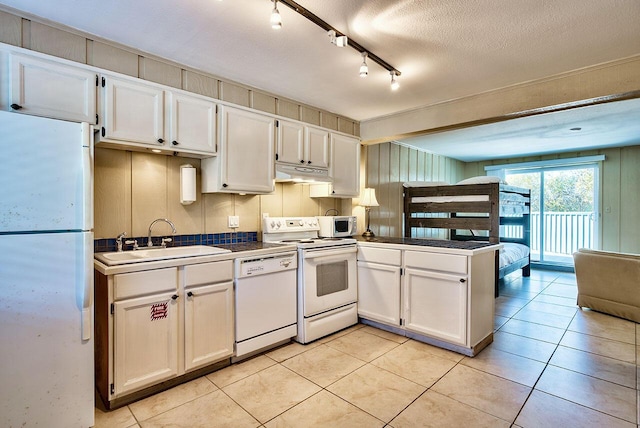 kitchen featuring white appliances, white cabinetry, and sink