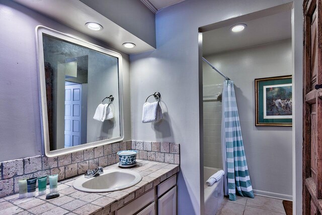 bathroom with decorative backsplash, vanity, tile patterned flooring, and shower / tub combo with curtain