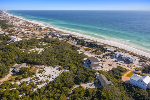 birds eye view of property featuring a water view and a beach view