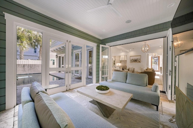 sunroom / solarium featuring a chandelier, wooden ceiling, and french doors