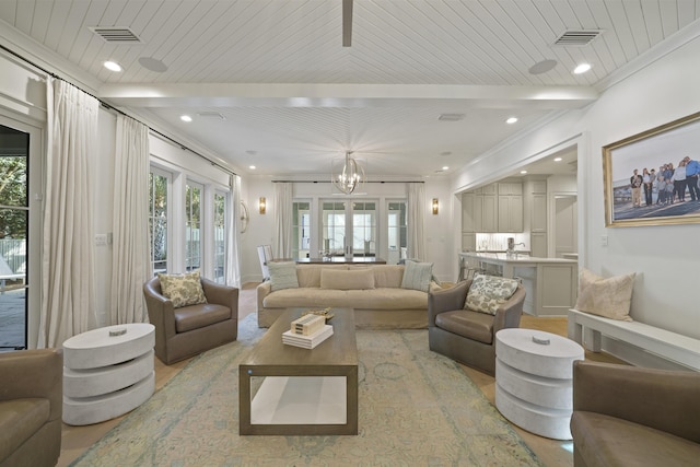 living room with light hardwood / wood-style floors, wooden ceiling, ornamental molding, and a chandelier