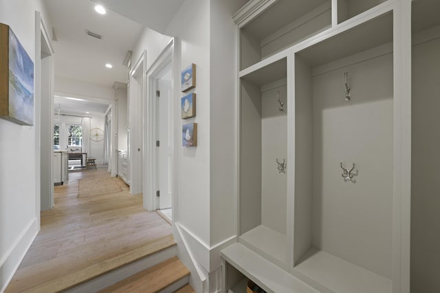 mudroom with light hardwood / wood-style floors