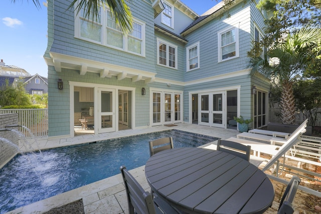 back of property with a patio area and french doors