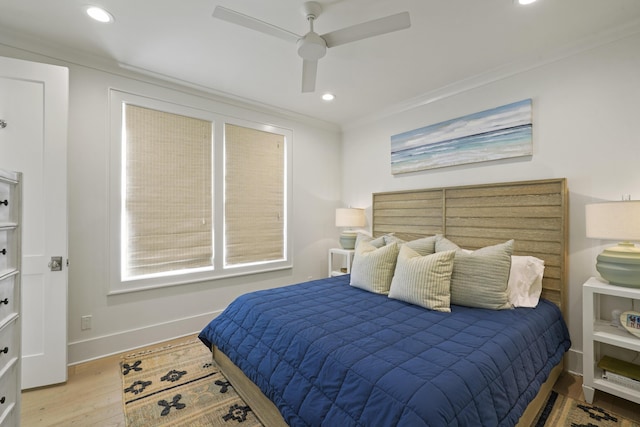 bedroom featuring ceiling fan, light hardwood / wood-style flooring, and crown molding