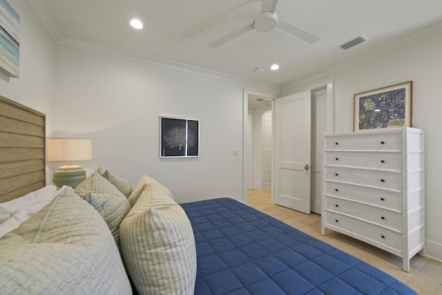 bedroom with ceiling fan, light wood-type flooring, and ornamental molding