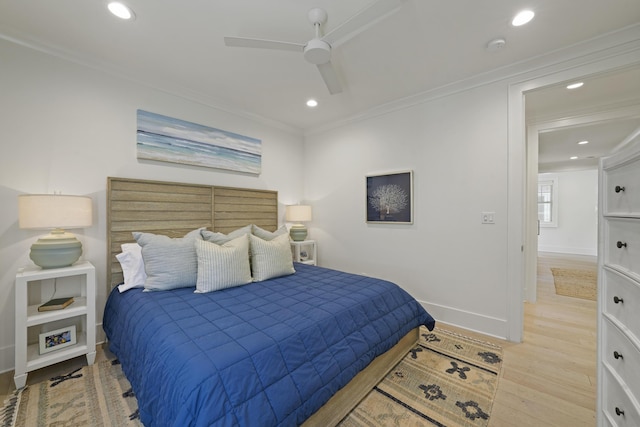 bedroom with light wood-type flooring, ceiling fan, and crown molding