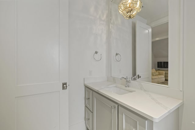 bathroom featuring a notable chandelier and vanity