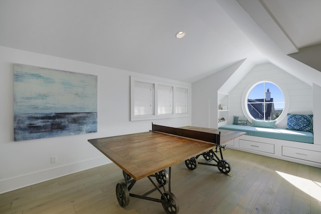 misc room featuring vaulted ceiling and light hardwood / wood-style flooring