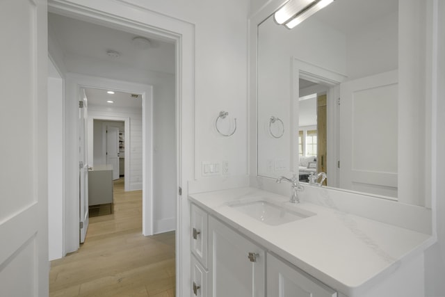 bathroom with hardwood / wood-style floors and vanity