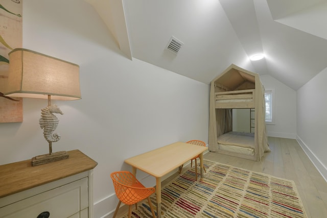 interior space with light wood-type flooring and lofted ceiling