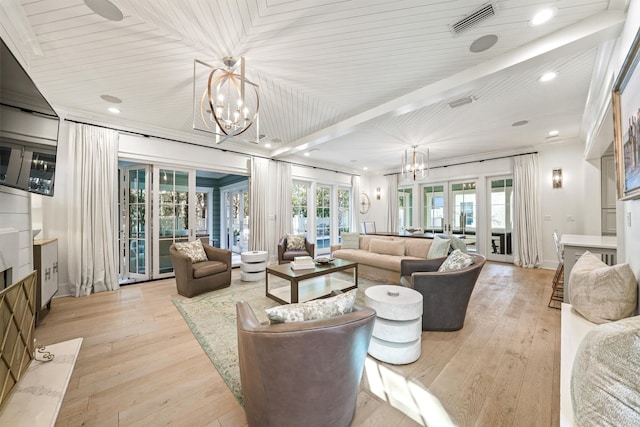 living room with visible vents, light wood finished floors, french doors, and an inviting chandelier