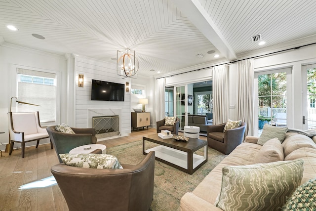 living room featuring hardwood / wood-style flooring, a healthy amount of sunlight, and a notable chandelier