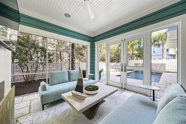 sunroom featuring outdoor lounge area and french doors