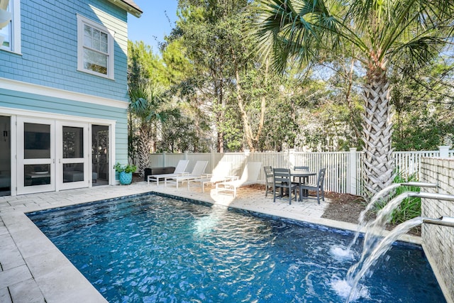 view of pool featuring fence, a fenced in pool, french doors, and a patio