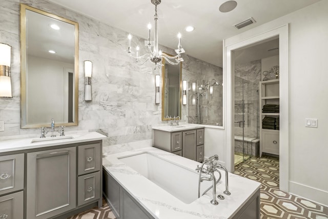 bathroom featuring a shower stall, visible vents, a washtub, and a sink