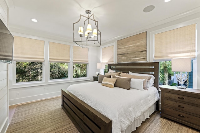 bedroom featuring baseboards, an inviting chandelier, wood finished floors, and recessed lighting