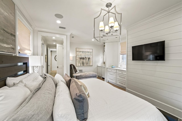 bedroom with visible vents, an inviting chandelier, recessed lighting, wood finished floors, and ornamental molding