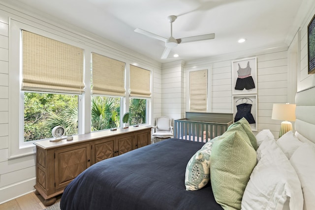 bedroom with a ceiling fan, wood finished floors, recessed lighting, and multiple windows