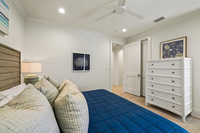 bedroom with recessed lighting, wood finished floors, visible vents, and ornamental molding