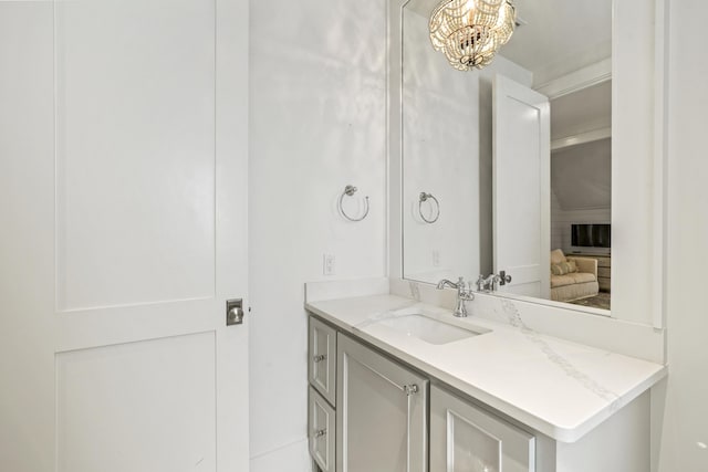 bathroom with vanity and a chandelier