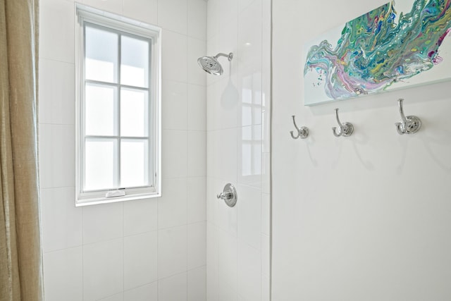 bathroom with a tile shower